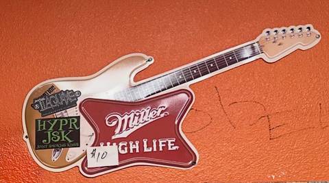 Miller High Life guitar-shaped metal sign