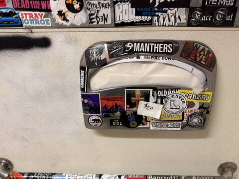 Chrome toilet seat cover dispenser, sticker-bombed