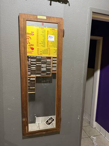 Long wood-frame wall mirror